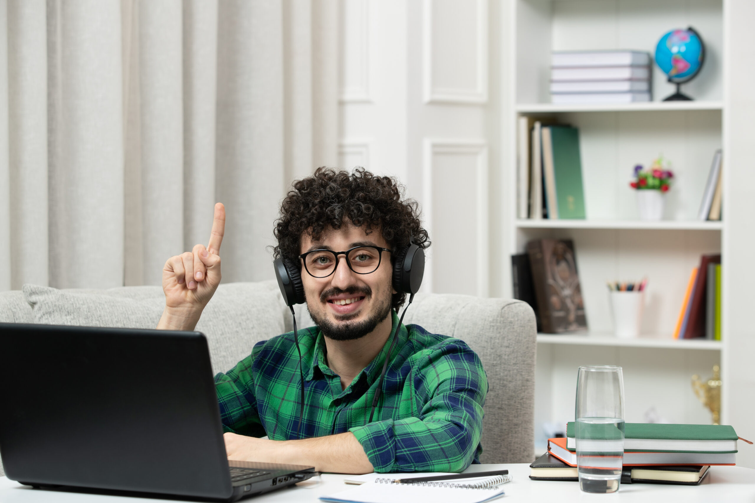student-online-cute-young-guy-studying-computer-glasses-green-shirt-smiling-pointing